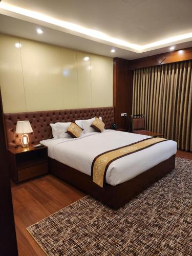 a bedroom with a large bed in a room at Paragon Hotel & Resort in Sreemangal