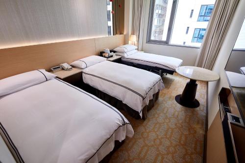 Postel nebo postele na pokoji v ubytování K Hotel Tianjin