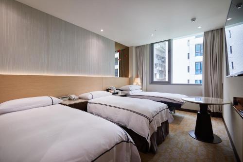 Postel nebo postele na pokoji v ubytování K Hotel Tianjin
