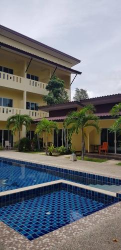 a swimming pool in front of a building at Khaolak Summer House 2 in Khao Lak