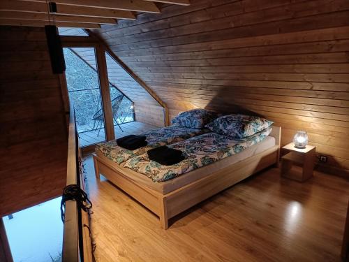 a bedroom with a bed in a wooden room at Czarna Chata in Jaworzynka