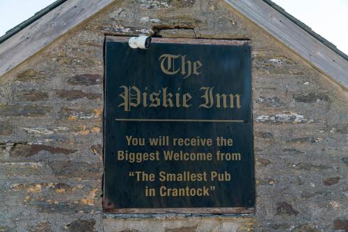 a sign on the side of a building at Camping Pods Trevella Holiday Park in Crantock