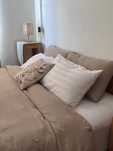 a couch with three pillows on top of it at Maryland Khaoyai Annapolis Pool Villa in Ban Nong Song Hong