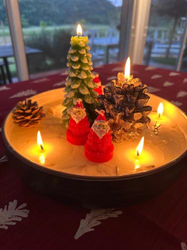 a plate with candles and christmas trees on a table at Maryland Khaoyai Annapolis Pool Villa in Ban Nong Song Hong