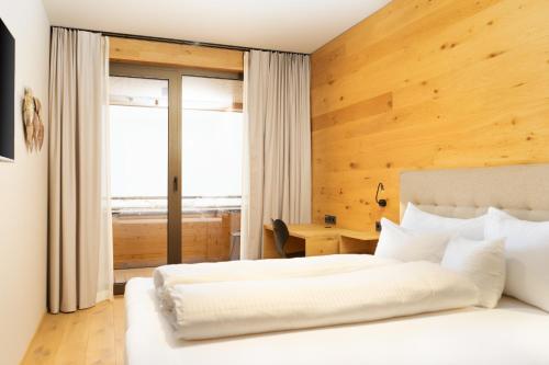 En eller flere senge i et værelse på Heimat 1495m Appartements TYP 1