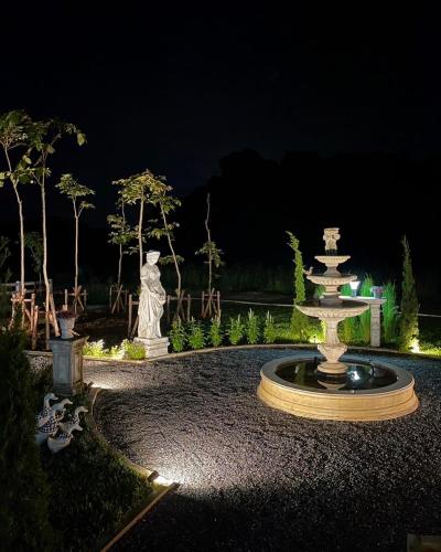 a fountain in the middle of a garden at night at Maryland Khaoyai Annapolis Pool Villa in Ban Nong Song Hong