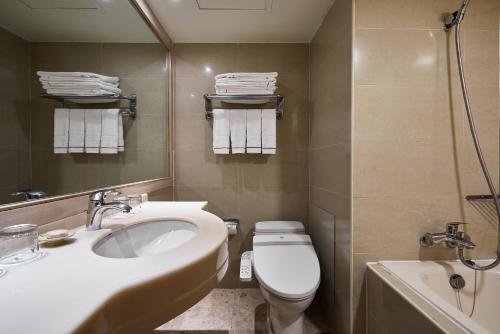 a bathroom with a sink and a toilet and a tub at K Hotel Taipei in Taipei