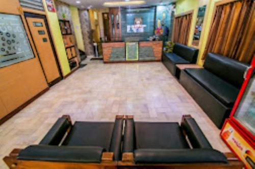 a room with couches and a television in a building at Hotel Akashdeep, Ranchi in Rānchī