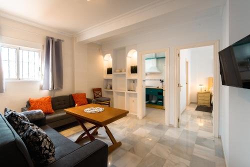 a living room with a couch and a table at Victoria 5 Apartment in Seville