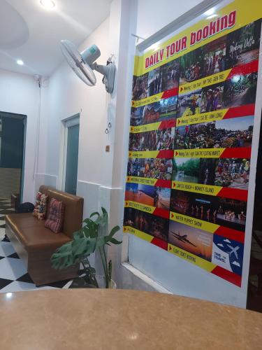 a room with a couch and a large poster on the wall at Saigon Rooftops Hostel in Ho Chi Minh City