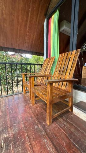 a wooden bench sitting on top of a porch at Fair View Cottage in Ella