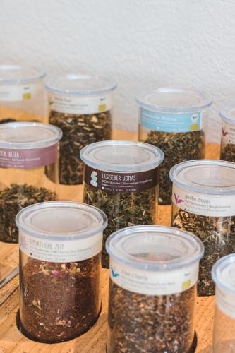 a group of jars of seeds sitting on a table at Die Seefelderin - Boutiquehotel St. Georg in Seefeld in Tirol