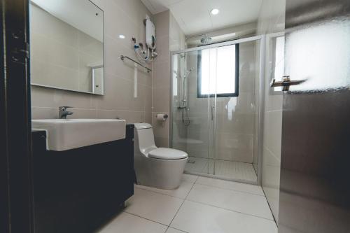 a bathroom with a shower and a toilet and a sink at Tranquil Sea View Danga Bay 3BR 6pax by Our Stay in Johor Bahru