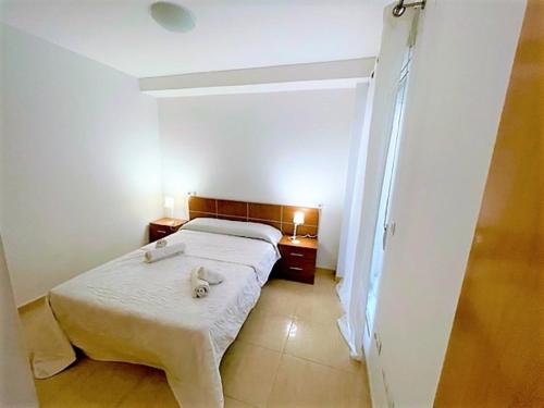 a bedroom with a bed and two night stands at Apartment Grao de Moncofar Ref 041 in Moncófar