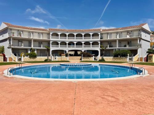 a large building with a large pool in front of it at Apartamento Vacacional Vela Blanca Moncofa Ref 055 in Peniscola
