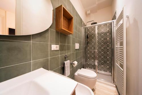 a bathroom with a toilet and a sink and a mirror at Reggio Center Lovely Rooms in Reggio Emilia