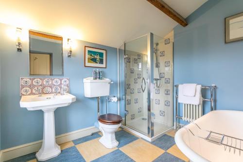 a bathroom with a toilet sink and a shower at Yellison at Broughton Sanctuary in Skipton