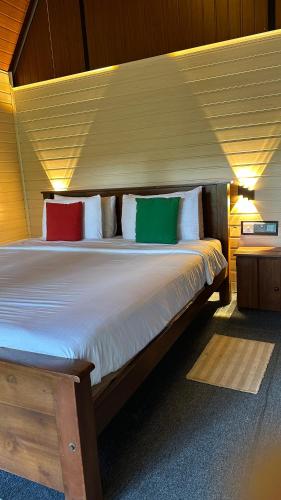 a large bed with four pillows in a room at Fair View Cottage in Ella