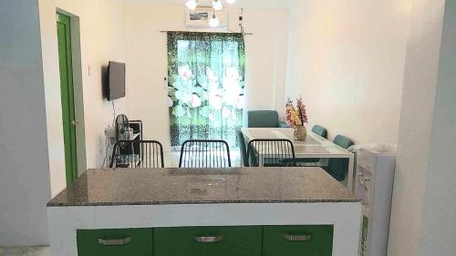 a room with a kitchen with a table and chairs at DeiHouse in Samal