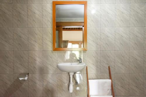 a bathroom with a sink and a mirror at TwoSpaces Living at Balian Green Lagoon in Balian
