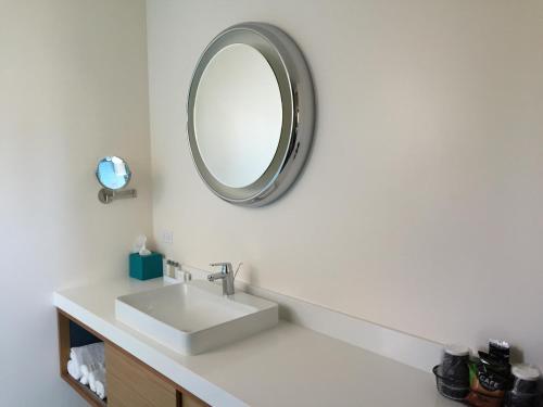 a bathroom with a sink and a mirror at The Beverly Laurel Hotel at West Hollywood in Los Angeles