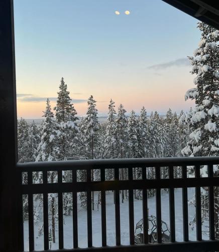 a view from a balcony of snow covered trees at Grand Hideout Levi in Kittilä