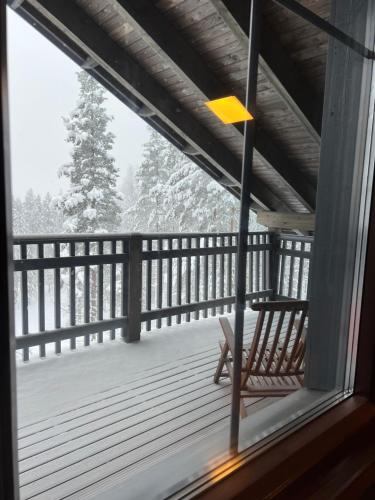 a view from a window of a porch with a bench at Grand Hideout Levi in Kittilä