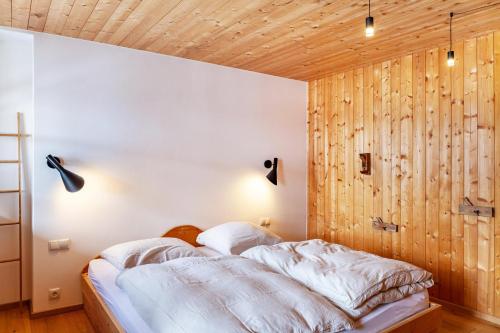 a bedroom with wood paneled walls and a bed at Chalet Flocke Sternschnuppe in Sankt Anton am Arlberg