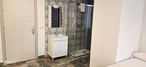 a bathroom with a shower and a sink at HOSTAL NERVION in Seville