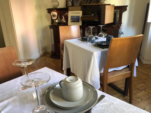 a table with a white table cloth and a plate on it at Casa da Branca Gonta Colaço in Lisbon
