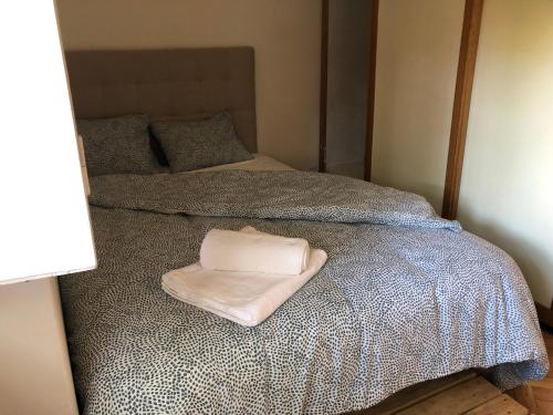 a bed with a white towel on top of it at Casa da Branca Gonta Colaço in Lisbon