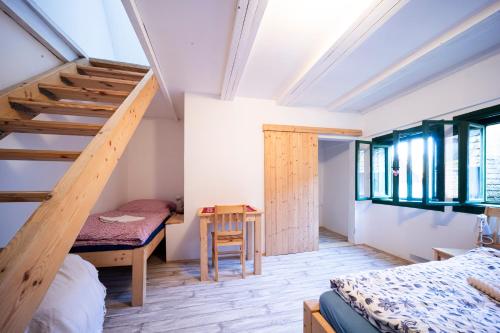 a bedroom with a bunk bed and a staircase at Sklípek Na Císařské in Moravany