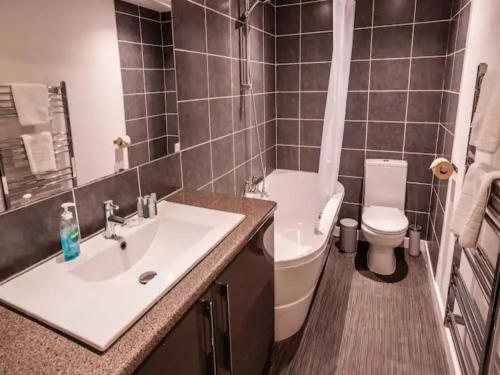 uma casa de banho com um lavatório branco e um WC. em Newly renovated ideally situated 2 bedroom flat em Bournemouth