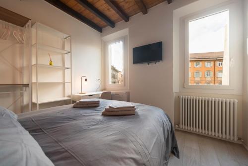 a bedroom with a bed with two towels on it at Reggio Center Lovely Rooms in Reggio Emilia