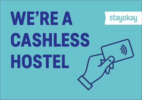 a hand holding a phone with the words were a cashless hospital at Stayokay Hostel Amsterdam Vondelpark in Amsterdam