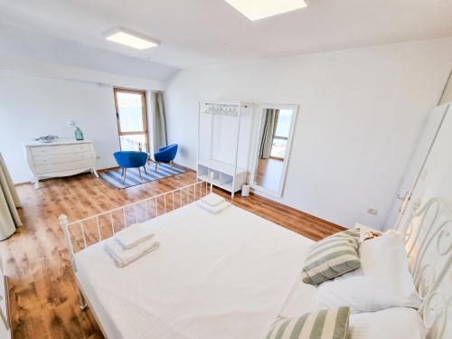 a white room with a bed and a mirror at Umag seafront seaview center apartments old town 1,2,3,4 by Rentistra in Umag