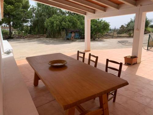 a wooden table and chairs on a patio at Casa Teatro Raices in Taberno