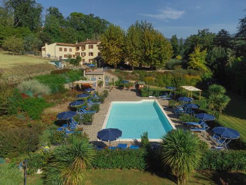 an aerial view of a swimming pool with chairs and umbrellas at Agriturismo Torreghiotta in Pistoia