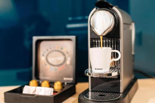 a coffee maker is making a cup of coffee at Refresh Boutique Apartments in Vodice