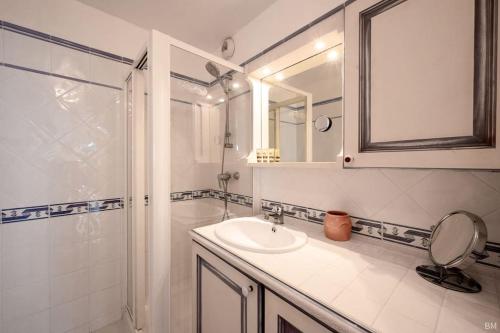 een badkamer met een wastafel, een douche en een spiegel bij Esprit du Sud Mascolo in Roquebrune-sur-Argens