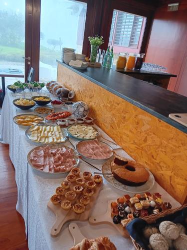 a buffet table with many different types of food at Quinta do Esquilo - Hotel Rural in Rendufe