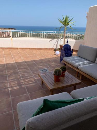 a patio with couches and a view of the ocean at Rincón de Hada in Mojácar
