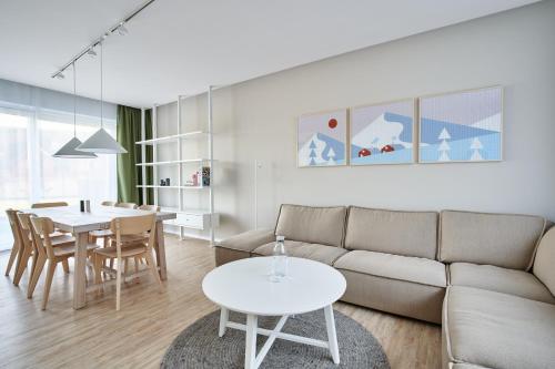 a living room with a couch and a table at Tatra Green in Veľká Lomnica
