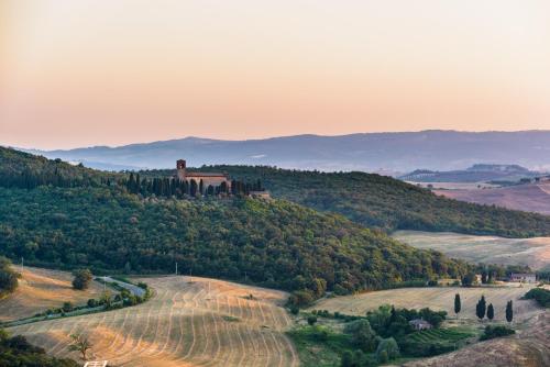 a view of a hill with a castle on it at Locanda di CasalMustia in Castelmuzio