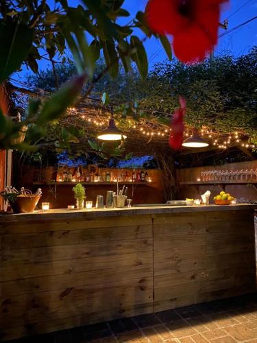 a bar with a counter with lights behind it at Posada Paradiso in José Ignacio