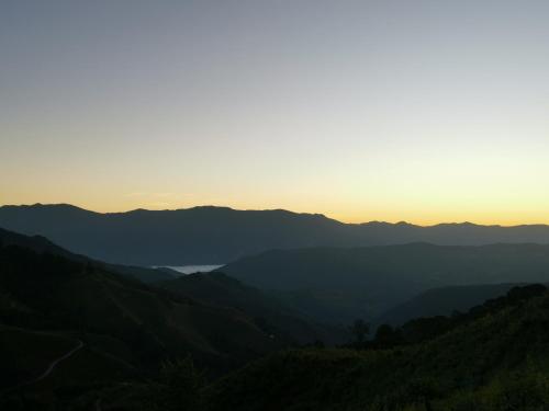 a view of the mountains at sunset at Panakluea at Kokuang Homestay in Ban Na Lae