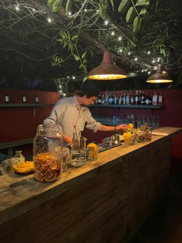 a chef preparing food at a counter in a restaurant at Posada Paradiso in José Ignacio