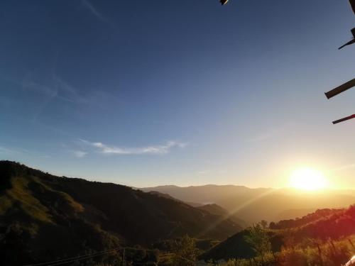 a view of the sun setting over a mountain range at Panakluea at Kokuang Homestay in Ban Na Lae