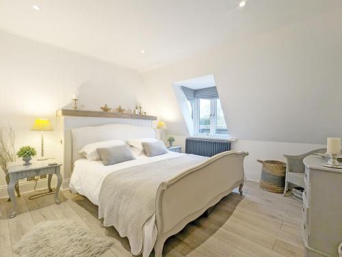 a bedroom with a large bed and a window at Thomond House, Midhurst in Midhurst