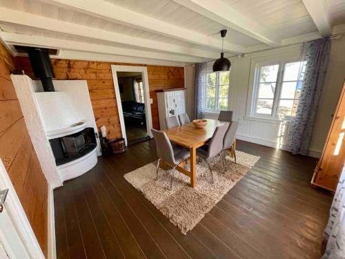 a dining room with a wooden table and chairs at Nordland House-Breathtaking View-Central Location in Sortland